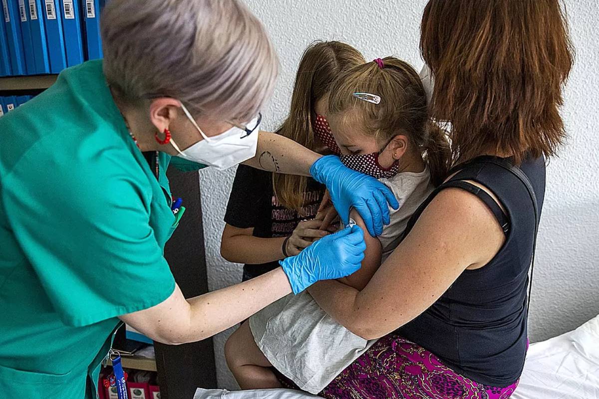 Una enfermera vacuna a dos niñas contra la covid. Foto: Foto: BERNARDO DÍAZ 