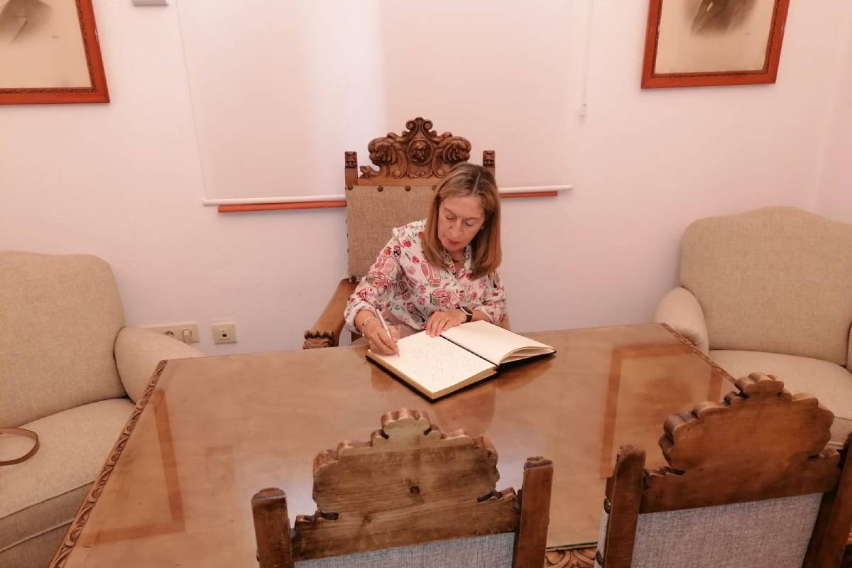 Ana Pastor, firmando en el libro de visitas del Museo del Colegio de Veterinarios de Badajoz (Muvet).