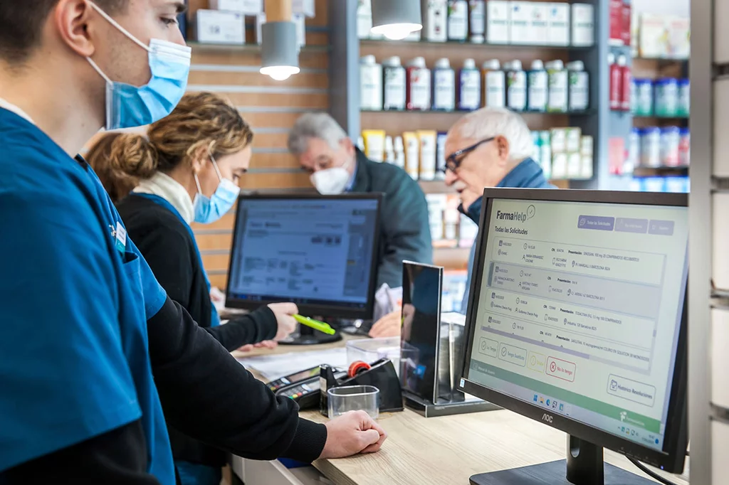 Los farmacéuticos de la farmacia Girona72 de Barcelona utilizan el programa informático ‘Farmahelp’ para buscar los medicamentos que faltan. Foto: SONIA TRONCOSO